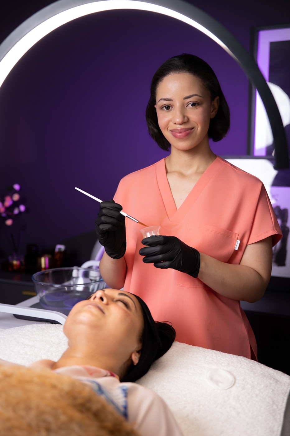 Caitlyn providing a facial treatment at Omnia